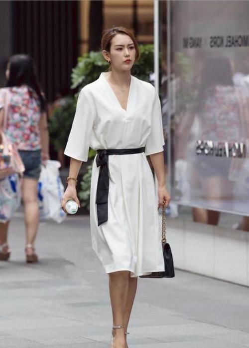  『长筒靴』路人街拍：美女腿型非常瘦，搭配黑色的长筒靴，格外的性感有魅力