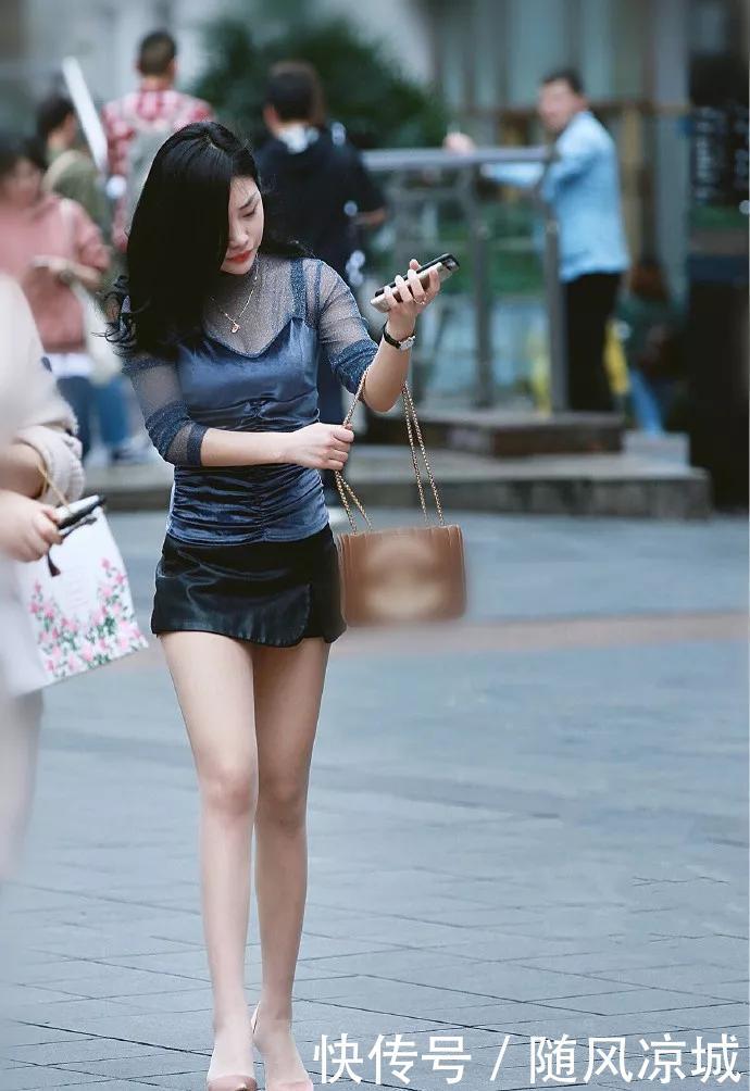  『十足』美女个子非常高，乌黑靓丽的秀发散落在肩上，妩媚感十足
