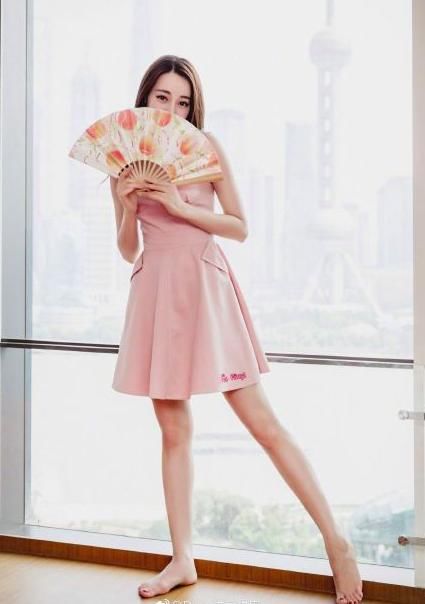 迪丽热巴赤脚穿粉裙露事业线，可手指怎么弯曲成这样了？