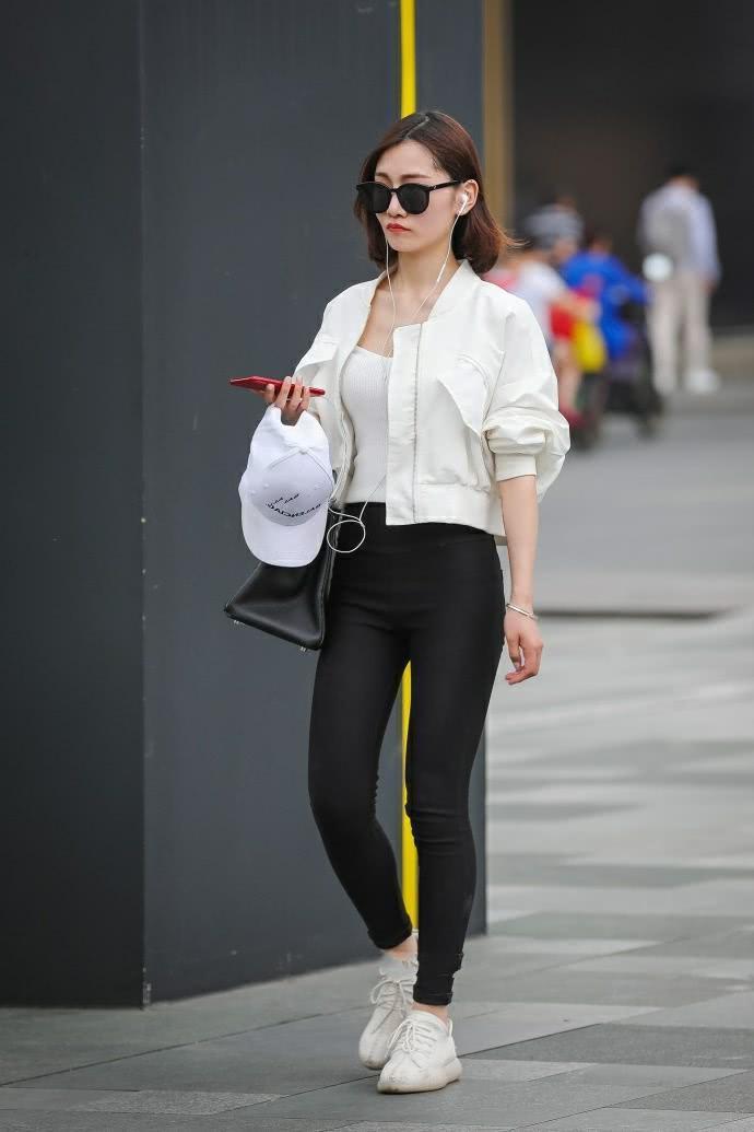 街拍：气质小姐姐紧身裤时尚美腿，一边走一边嘟嘴撩发萌态十足