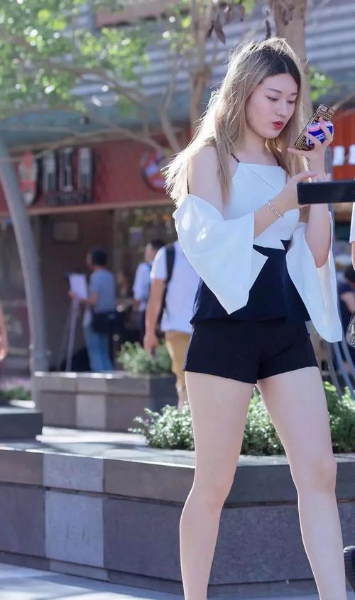 性感小姐姐身穿露背装搭配黑色超短裤，大秀美背十分性感