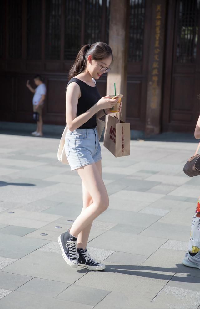 路人街拍，小姐姐穿着一件卡其色小吊带，简约又优雅时尚