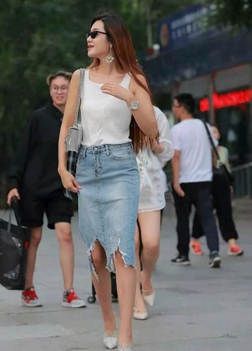  『半身裙』街拍：身材高挑的美女，一件白色背心配牛仔半身裙，完美好身材